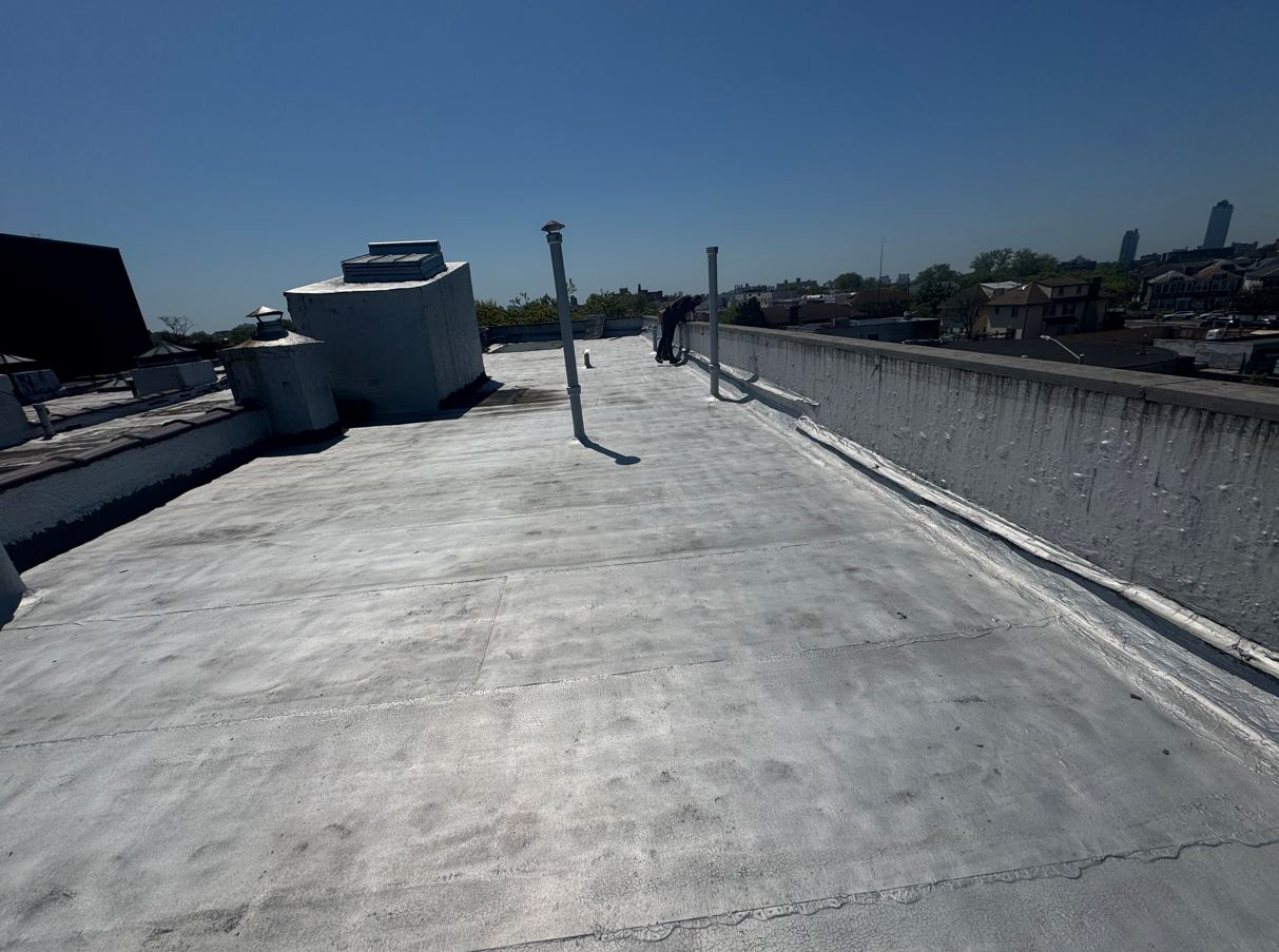 Silver-coated commercial flat roof with parapets