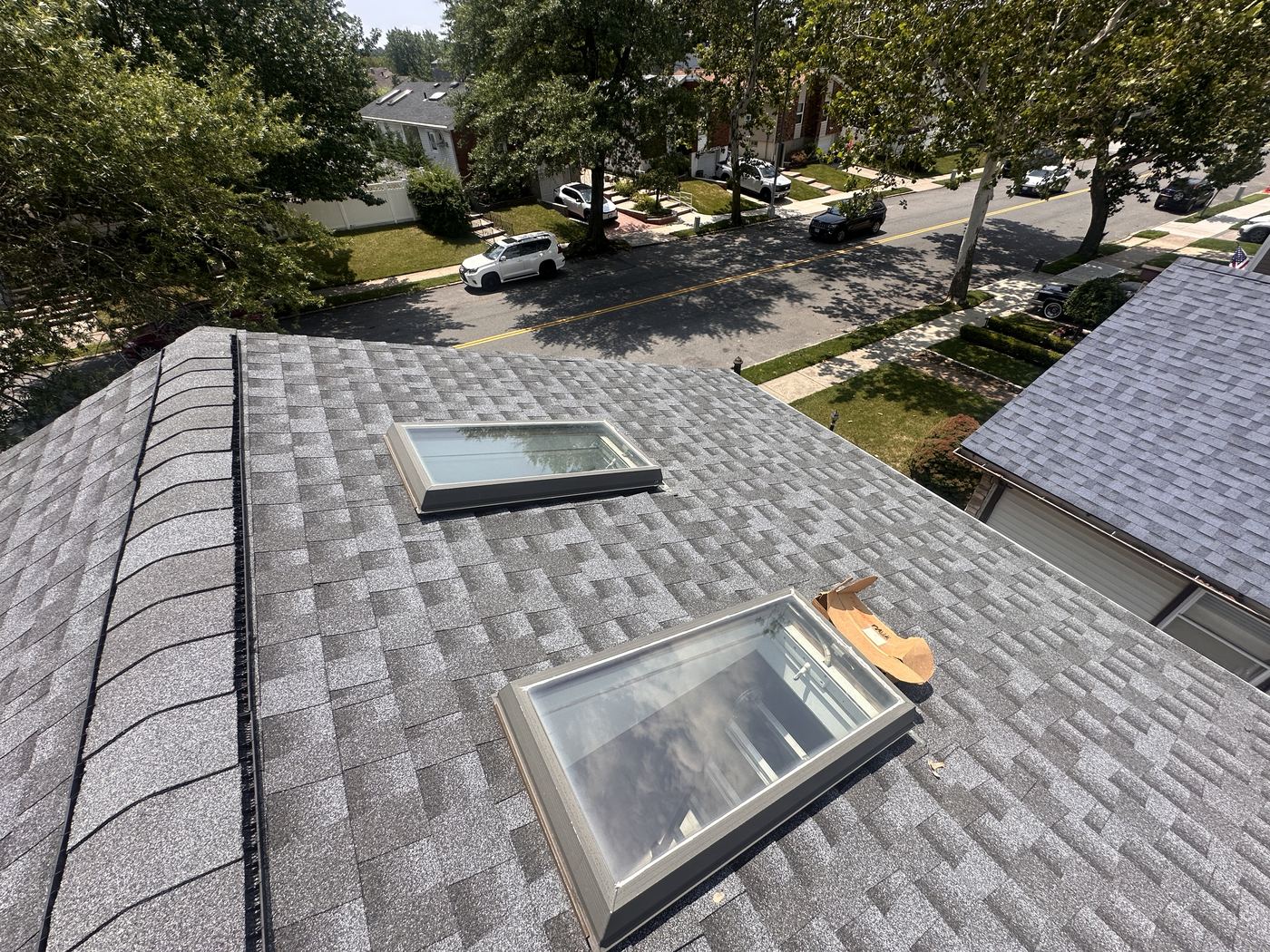 Shingle roof slope with skylights from ridge